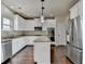 Bright kitchen boasts stainless appliances, granite countertops, hardwood flooring and white cabinetry at 1465 Forest Brook Trl, Cumming, GA 30041