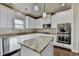 This kitchen features stainless appliances, granite countertops, and white cabinetry and an island at 1465 Forest Brook Trl, Cumming, GA 30041