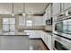 Bright kitchen features stainless steel appliances, granite countertops, and hardwood flooring at 1465 Forest Brook Trl, Cumming, GA 30041