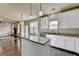 Modern kitchen features stainless steel appliances, granite countertops, hardwood flooring and open access to the living room at 1465 Forest Brook Trl, Cumming, GA 30041