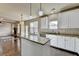 Open kitchen with granite island, stainless appliances and hardwood floors leads to living area with fireplace at 1465 Forest Brook Trl, Cumming, GA 30041