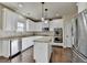 Bright kitchen features stainless appliances, granite countertops, hardwood flooring and white cabinetry at 1465 Forest Brook Trl, Cumming, GA 30041