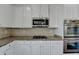 Granite countertops, stainless appliances and white cabinetry are highlights of this kitchen at 1465 Forest Brook Trl, Cumming, GA 30041