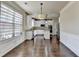 Open-concept kitchen and dining area with hardwood floors, stainless appliances, and an abundance of natural light at 1465 Forest Brook Trl, Cumming, GA 30041