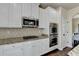 This kitchen features stainless appliances, granite countertops, and white cabinetry at 1465 Forest Brook Trl, Cumming, GA 30041