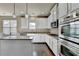 Modern kitchen features stainless steel appliances, granite countertops, hardwood flooring and eat in island at 1465 Forest Brook Trl, Cumming, GA 30041