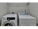 Laundry room with white Samsung washing machine and dryer at 1465 Forest Brook Trl, Cumming, GA 30041