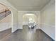 The Living Area features decorative molding on the walls, hardwood floors, and arched doorways leading to other rooms at 1465 Forest Brook Trl, Cumming, GA 30041