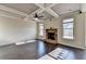 Bright living room has a stone fireplace, coffered ceiling, and hardwood floors at 1465 Forest Brook Trl, Cumming, GA 30041