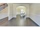 Open-concept living room with hardwood floors flowing into the dining area at 1465 Forest Brook Trl, Cumming, GA 30041