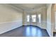 Bright living room featuring dark wood floors, crown molding, and a bay window at 1465 Forest Brook Trl, Cumming, GA 30041