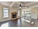 Open-concept living room with coffered ceiling that flows into the modern kitchen at 1465 Forest Brook Trl, Cumming, GA 30041