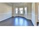 Bright living room featuring hardwood floors and large bay windows at 1465 Forest Brook Trl, Cumming, GA 30041