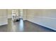 Open-concept living room with hardwood floors that connect to the dining room at 1465 Forest Brook Trl, Cumming, GA 30041