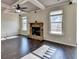 Open-concept living room features a stone fireplace and coffered ceilings at 1465 Forest Brook Trl, Cumming, GA 30041