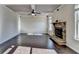 Open-concept living room with coffered ceiling and a stone fireplace at 1465 Forest Brook Trl, Cumming, GA 30041