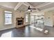 Open-concept living room has a stone fireplace, coffered ceiling, and hardwood floors at 1465 Forest Brook Trl, Cumming, GA 30041