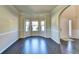 Bright living room featuring dark wood floors, crown molding, and a bay window at 1465 Forest Brook Trl, Cumming, GA 30041