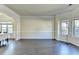 Spacious living room featuring dark wood floors, crown molding, and large windows at 1465 Forest Brook Trl, Cumming, GA 30041