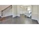 Living room leading to dining area with elegant staircase on the left side at 1465 Forest Brook Trl, Cumming, GA 30041