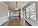 Open-concept living room with coffered ceilings, hardwood floors, and abundant natural light at 1465 Forest Brook Trl, Cumming, GA 30041