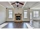 Living room boasts a stone fireplace, hardwood floors, and coffered ceilings at 1465 Forest Brook Trl, Cumming, GA 30041