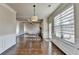 Open-concept living space with hardwood floors, a fireplace, and an abundance of natural light from large windows at 1465 Forest Brook Trl, Cumming, GA 30041