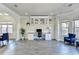 Home office area featuring a custom desk, shelving, and large windows at 1465 Forest Brook Trl, Cumming, GA 30041