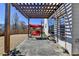 Cozy covered patio with a red swing, perfect for outdoor relaxation and entertaining on a sunny day at 1465 Forest Brook Trl, Cumming, GA 30041