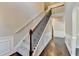 View of the home's carpeted staircase with decorative iron spindles and wood floors at 1465 Forest Brook Trl, Cumming, GA 30041