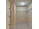 Bright walk-in closet with neutral paint and carpet, with wire shelving for organization at 1465 Forest Brook Trl, Cumming, GA 30041