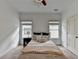 Carpeted bedroom featuring a ceiling fan and two bright windows at 875 Olmsted Ln, Duluth, GA 30097