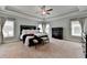 Main bedroom with tray ceiling, carpet, many windows, a king bed, and dark wood furniture at 875 Olmsted Ln, Duluth, GA 30097