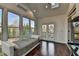 Well-lit sunroom boasting hardwood floors, skylights, and French doors to the outdoor space at 875 Olmsted Ln, Duluth, GA 30097