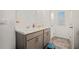 Double vanity with marble countertops, gray cabinets, and tiled floors at 1026 King Iron Dr, Lawrenceville, GA 30045