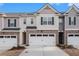 Attractive townhome featuring a two-car garage and appealing architectural details at 1026 King Iron Dr, Lawrenceville, GA 30045