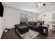 Living room with a view of kitchen, hardwood floors, and a comfortable sectional sofa at 1026 King Iron Drive Dr, Lawrenceville, GA 30045