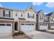 Row of new townhomes with 2 car garages, landscaping, and sidewalks at 1026 King Iron Drive Dr, Lawrenceville, GA 30045