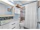 Bright bathroom features a shower-tub combo with stylish tile and a marble countertop vanity at 2599 Church Nw St, Atlanta, GA 30318