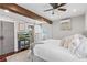 Bedroom features barn door to the bathroom, beamed ceiling, and hardwood floors at 2599 Church Nw St, Atlanta, GA 30318
