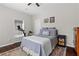 Cozy bedroom with hardwood floors, ceiling fan, and a comfortable bed at 2599 Church Nw St, Atlanta, GA 30318