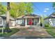 Charming cottage-style home with a well-maintained lawn and a welcoming red front door at 2599 Church Nw St, Atlanta, GA 30318