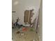 Damaged storage area shows exposed plumbing, debris-strewn floor, and damaged drywall at 1775 Hadlock Sw St, Atlanta, GA 30311