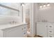 Bathroom featuring dual vanities with marble countertops and natural light from window at 2762 Whitehurst Ne Dr, Marietta, GA 30062