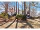 Charming two-story home with white siding, complemented by lush landscaping and mature trees at 2762 Whitehurst Ne Dr, Marietta, GA 30062