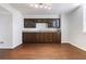 Large bonus room features an expansive wet bar with custom wood cabinetry and a hardwood floor at 2762 Whitehurst Ne Dr, Marietta, GA 30062