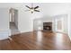 Inviting living room features a stone fireplace, wood floors, and access to the backyard at 2762 Whitehurst Ne Dr, Marietta, GA 30062