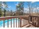Enjoy a refreshing pool view framed by a wood deck and lush landscaping; the perfect backyard oasis at 2762 Whitehurst Ne Dr, Marietta, GA 30062
