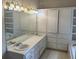 Well-lit bathroom featuring double sinks, and built-in storage cabinets for optimal organization at 3220 Indian Shoals Rd, Dacula, GA 30019