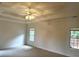 Bright bedroom with carpet, tray ceiling, a ceiling fan, and lots of natural light at 3220 Indian Shoals Rd, Dacula, GA 30019